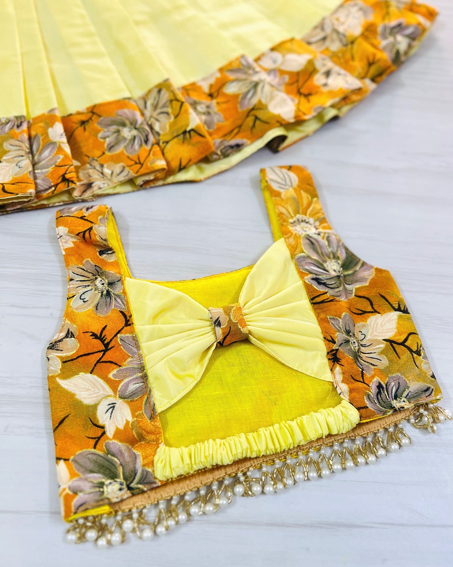 Autumn Glow Cute Bow Top With Hanging Pearls Lehenga Set | The Silkberry