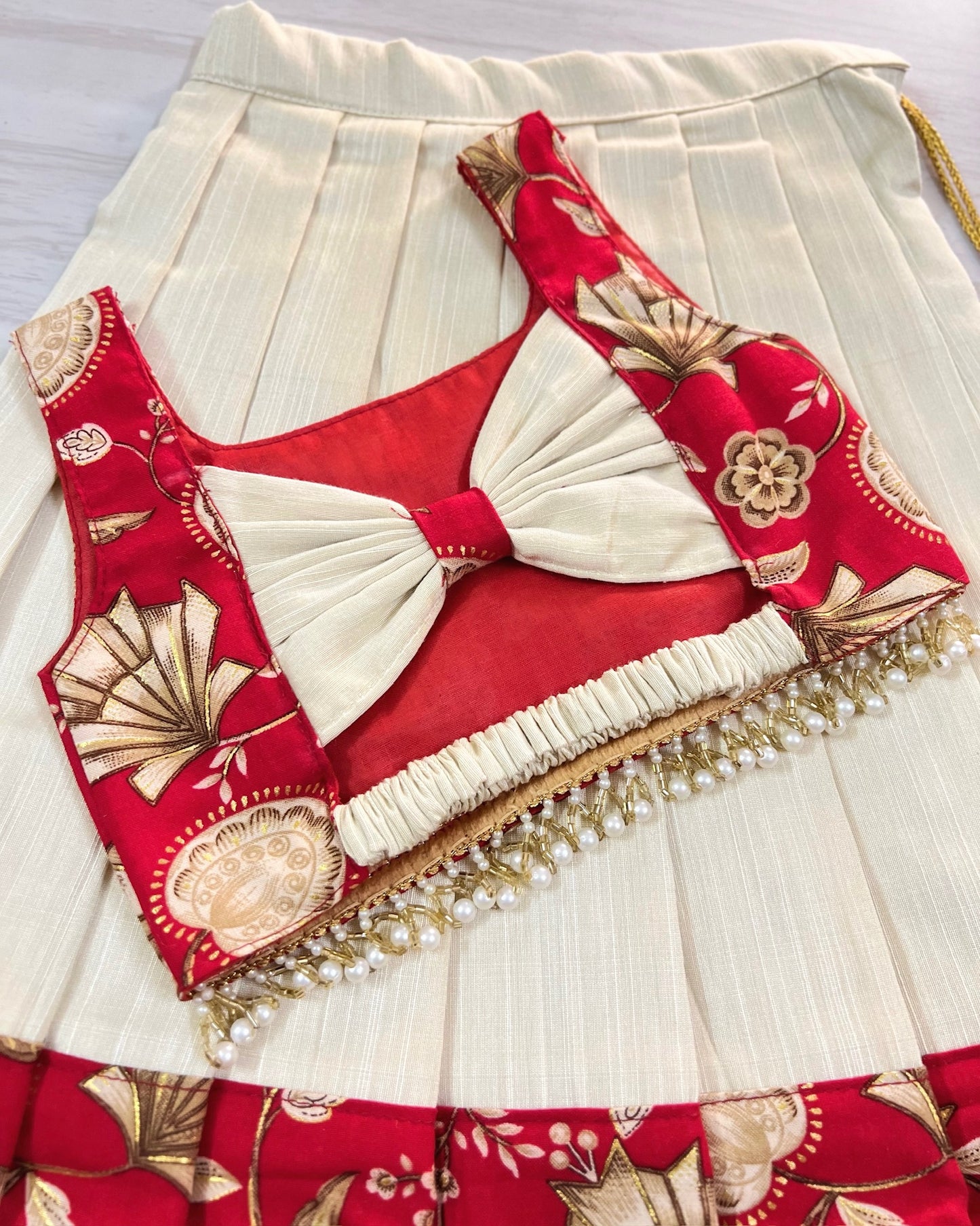 Scarlet Beauty Cute Bow Top With Hanging Pearls Lehenga Set | The Silkberry