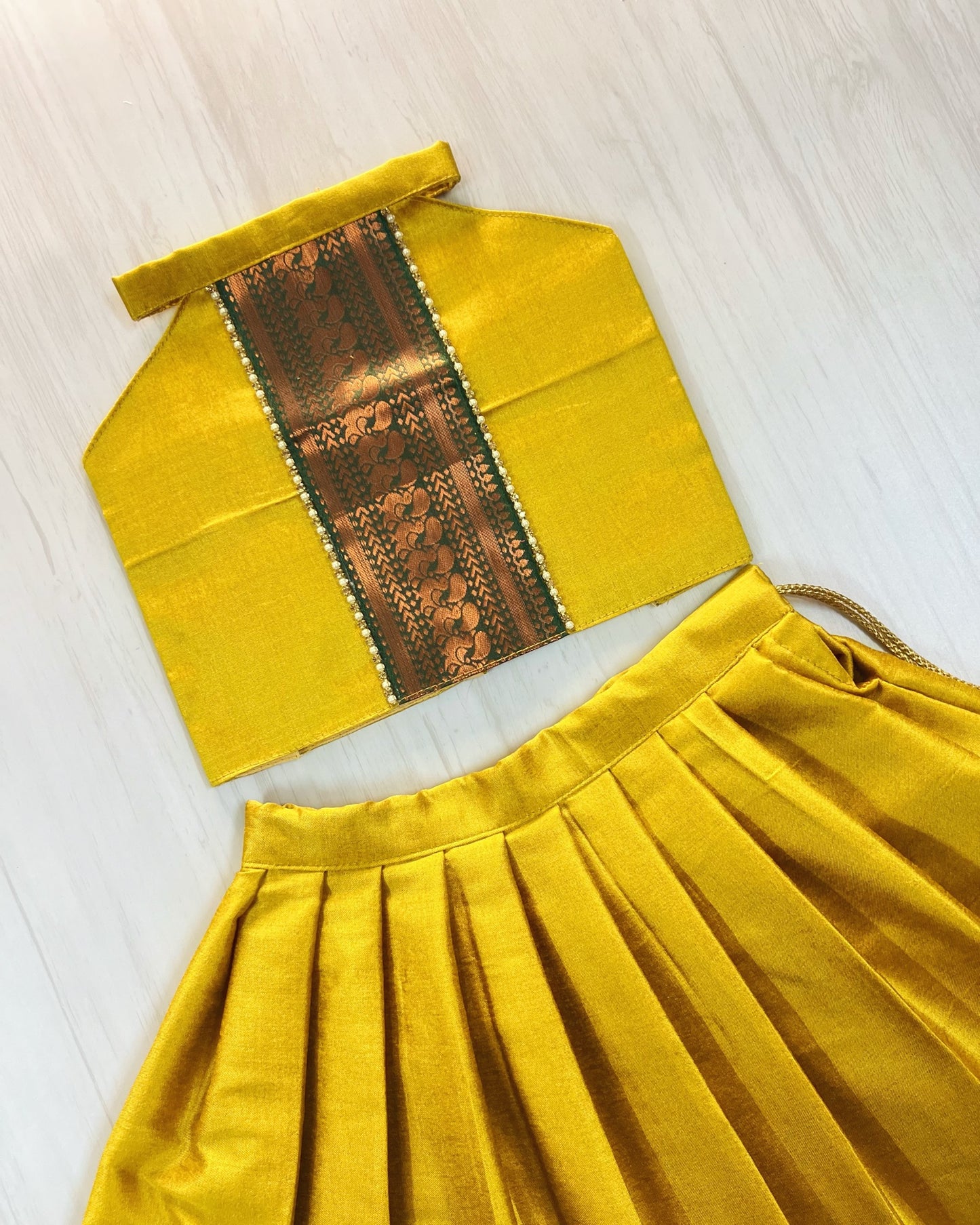 Auspicious Yellow With Emerald Green Halter Neck Lehenga Set