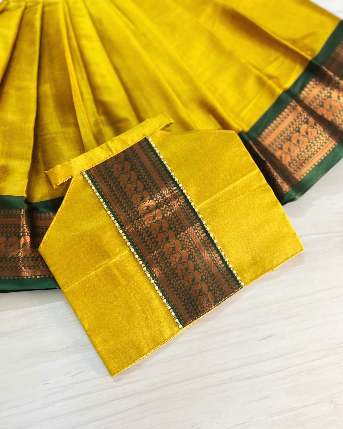 Auspicious Yellow With Emerald Green Halter Neck Lehenga Set