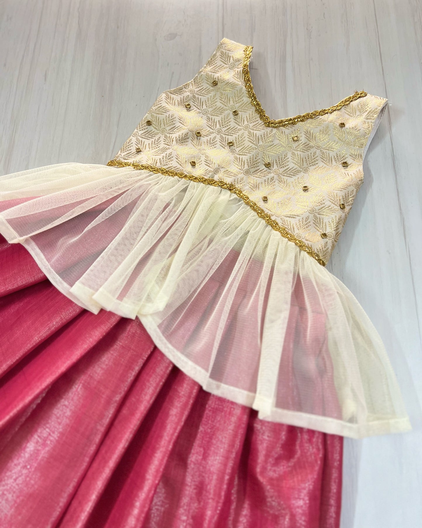 Rich Brocade Gold And Pink Netted Unique Lehenga Set